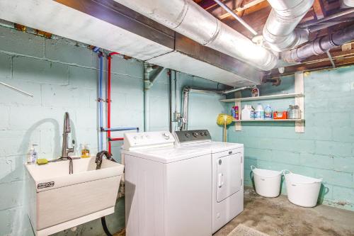 a laundry room with a washing machine and a sink at Anias Retreat with Deck Walk to Lake Michigan! in Two Rivers