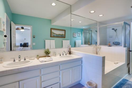 a bathroom with two sinks and a large mirror at Gorgeous Catalina Island Condo with Golf Cart! in Avalon