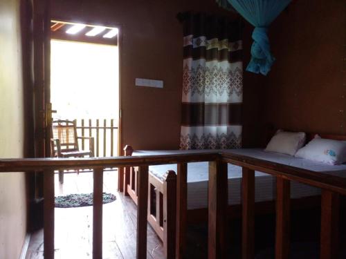 a room with a bunk bed and a balcony at Sinharaja Forest Lodge in Deniyaya