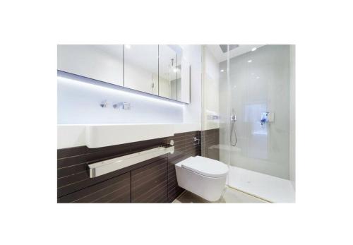 a bathroom with a toilet and a sink and a shower at Luxury Collection Riverside in London
