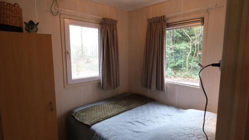 Ένα ή περισσότερα κρεβάτια σε δωμάτιο στο Vakantiehuis De Veldhoen vrijgelegen nabij de rivier de Vecht