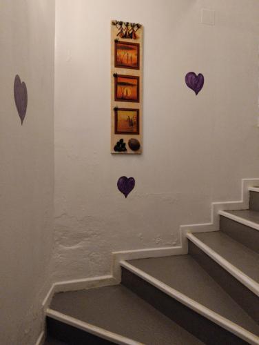 a hallway with hearts on the wall and stairs at LA BELLE IVOIRE in Saint-Marcel