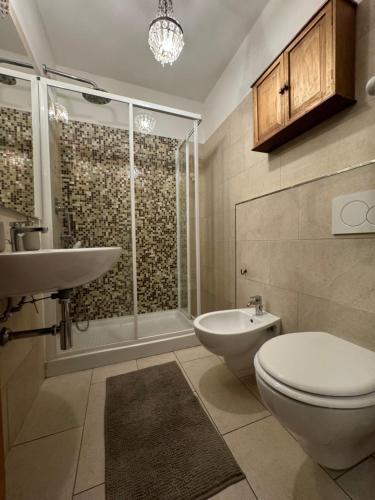a bathroom with a toilet and a sink and a shower at Casa. Grassi in Siena