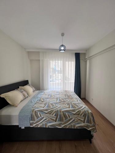 a bedroom with a large bed with a window at Allegro Apartments Kadıköy in Istanbul