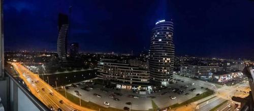 a view of a city at night with traffic at Apartament Renard in Rzeszów