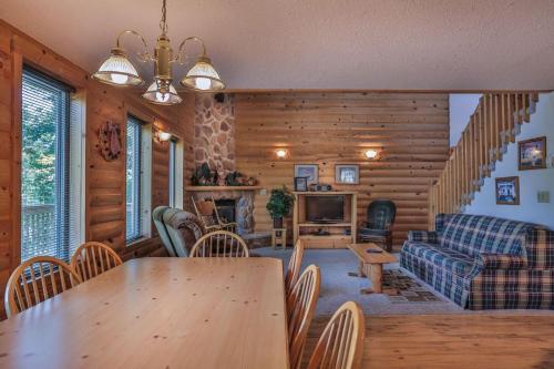 a living room with a table and a couch at Rustling Wind Haven in Lead
