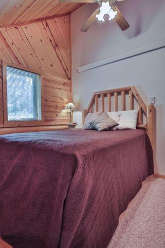 a bedroom with a large bed with a wooden ceiling at Rustling Wind Haven in Lead
