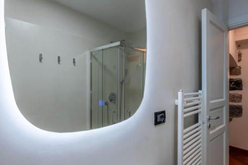 a bathroom with a shower and a mirror on the wall at Palazzo dei Rolli Charm [Centro Storico di Genova] in Genova