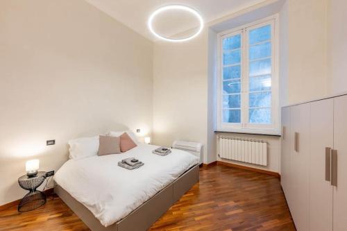 a bedroom with a white bed and a window at Palazzo dei Rolli Charm [Centro Storico di Genova] in Genova