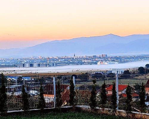 a view of a city with a beach at sunset at Sibiu City Lights in Şura Mare