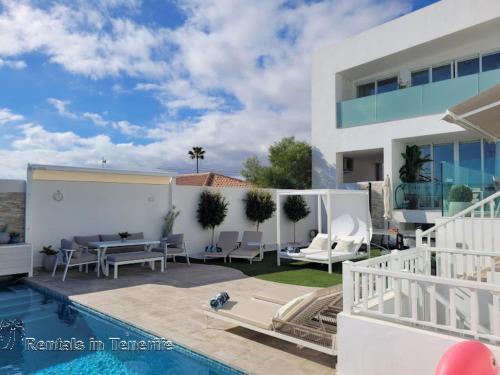 a villa with a swimming pool and a house at OCEAN MARINA GOLF Villa in San Miguel de Abona