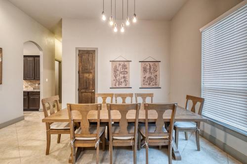 a dining room with a wooden table and chairs at Driftwood in Concan
