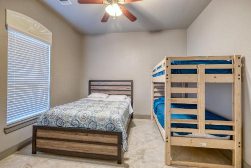a bedroom with a bunk bed and a ceiling fan at Driftwood in Concan