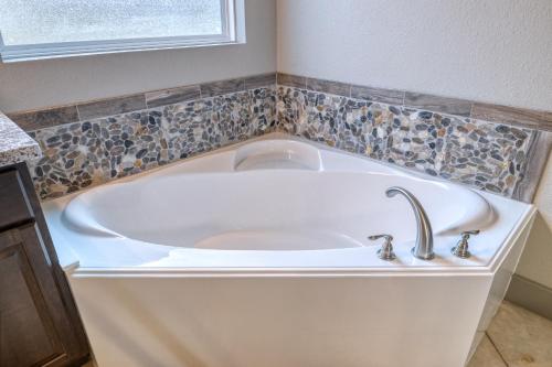 a white bath tub with a sink in a bathroom at Driftwood in Concan