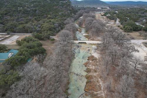 an aerial view of a river with trees at Driftwood in Concan