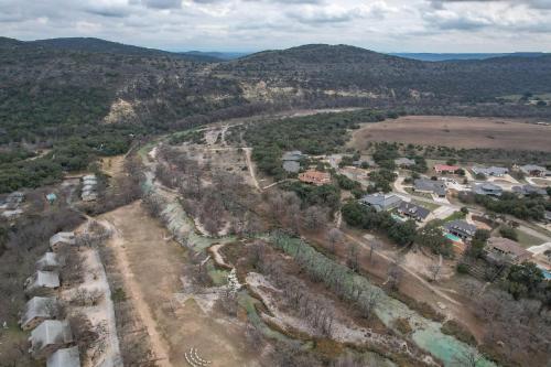 an aerial view of a village with houses and trees at Driftwood in Concan