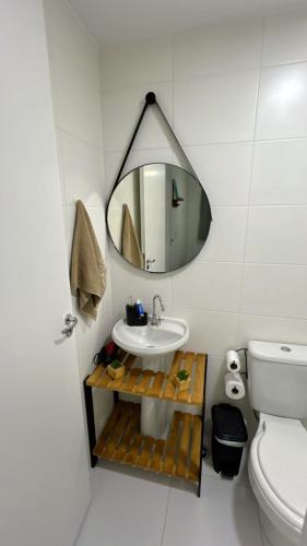 a bathroom with a sink and a mirror at Ponte Laguna, Parque Burle Max in Sao Paulo