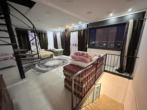 a living room with a couch and a balcony at Jericho Palestine, Panorama Villa- View, Full Privacy & Pool in Jericho