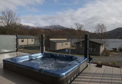 a hot tub on the roof of a house at Loch Lomond Holiday Park in Inversnaid