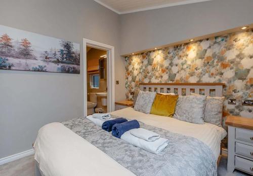 a bedroom with a bed with towels on it at Loch Lomond Holiday Park in Inversnaid