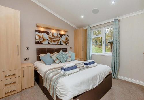 a bedroom with two beds and a window at Loch Lomond Holiday Park in Inversnaid