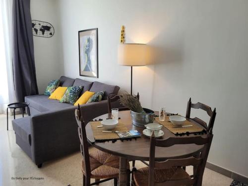 un salon avec une table et un canapé dans l'établissement Studio L'Echappée 3 étoiles, à Nyons