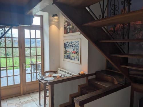 a room with stairs and a table and a window at Manoir du Boscau, Louis IX in Prudhomat