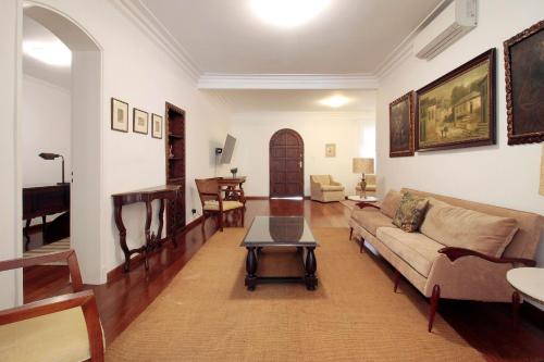 a living room with a couch and a table at Classic SP House in High End Neighborhood in Sao Paulo