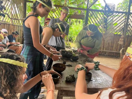a group of people standing around a table preparing food at Suchipakari Amazon Eco -Lodge & Jungle Reserve in Puerto Misahuallí