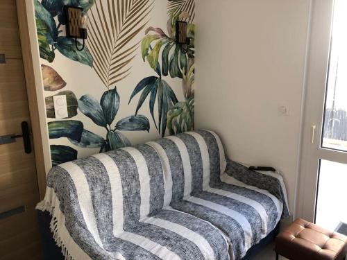 a couch in a room with a wall at Maison de vacances avec piscine , dans résidence in Meschers-sur-Gironde