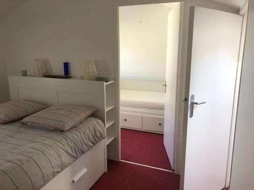 a small bedroom with a bed and a closet at Maison de vacances avec piscine , dans résidence in Meschers-sur-Gironde