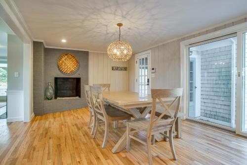 a dining room with a table and chairs and a fireplace at 1 Mi to Beach Cape Cod Family Home in Bourne! in Bourne