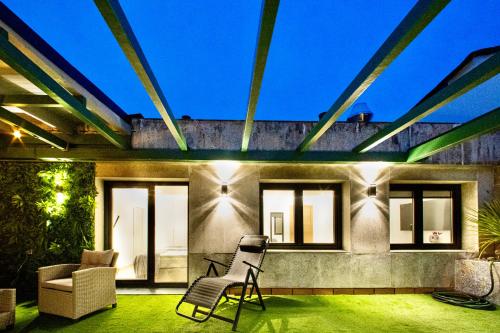 a house with two chairs on a patio at Lucus Skyline & Terrace by Lugo Collection in Lugo
