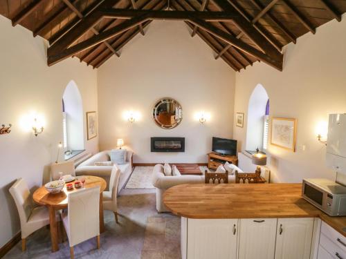 a living room with a couch and a table at Frogwell Chapel in Callington