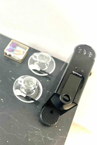 a cell phone sitting on top of a table at T1 - Le Papangue 5* - neuf, vue jardin, 8’ airport in Sainte-Clotilde