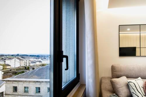 a window with a view of a city at Lucus Skyline & Terrace by Lugo Collection in Lugo