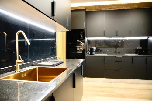 a kitchen with a sink and a counter top at Lucus Skyline & Terrace by Lugo Collection in Lugo