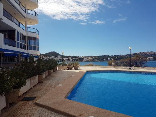 a large swimming pool next to a building at Mediterranean sea view apartment in Santa Ponsa