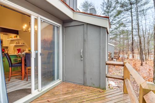 a sliding glass door on a deck with a table at Cozy Cabin with Deck Less Than 1 Mi to Jack Frost Resort! in White Haven