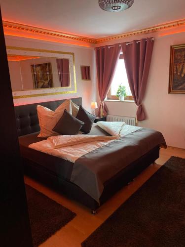 a large bed in a bedroom with a window at Pension King Royal in Hamburg