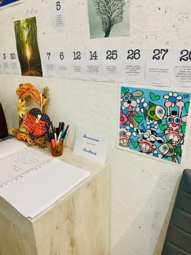 a desk with pens and a calendar on a wall at Luce in Serramanna