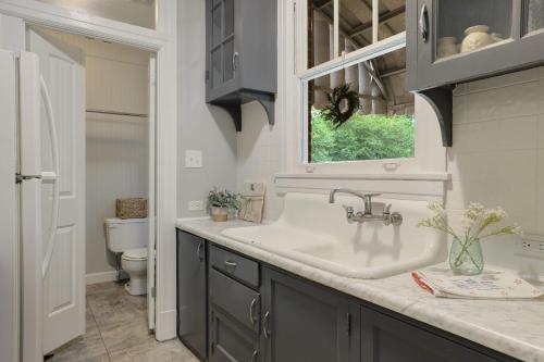 a bathroom with a sink and a toilet at Large Groups Welcome - 2 Homes Next Door in New Iberia