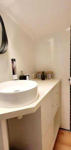 a bathroom with a white sink in a room at Entre 2 flots 1 in Le Tréport
