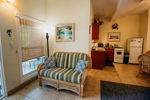 a living room with a chair and a kitchen at Indigo in Cruz Bay