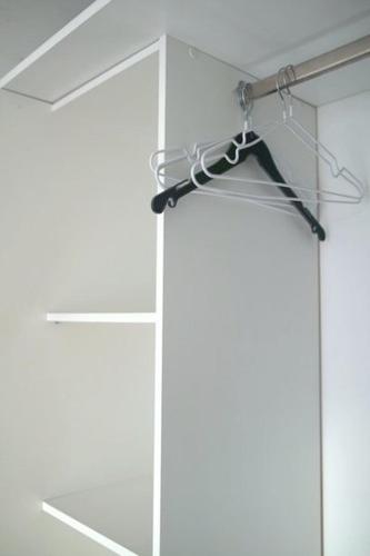 a closet with a glass door with a hanger at Chic Retreat near Paris in Saint-Ouen