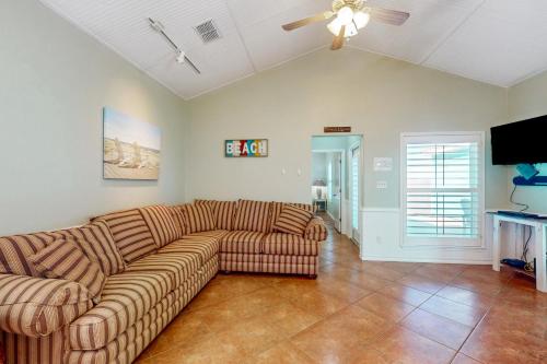 a living room with a couch and a ceiling fan at Marquesas 401 in Padre Island