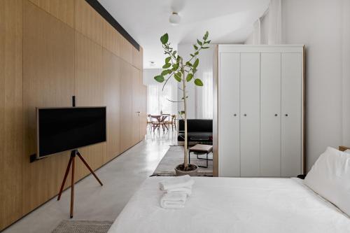 a bedroom with a tv on a wall at Rothschild 69 in Tel Aviv