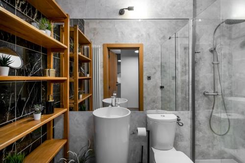 a bathroom with a toilet and a glass shower at Huge Luxury House - 6 floors-6 Bedrooms- center in Warsaw