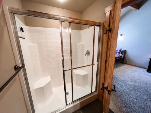 a shower in a bathroom with a glass door at Grand View Lodge in Whitefish