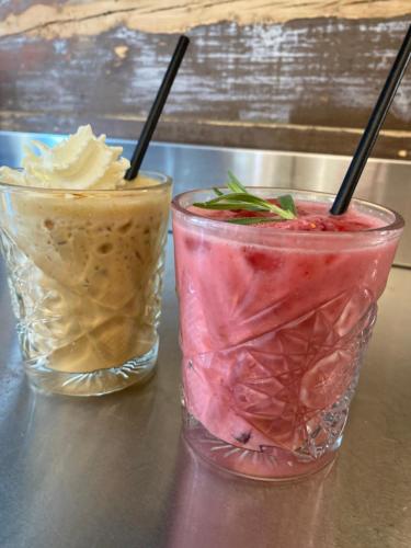 two drinks in glasses sitting on a table at Bed and Brunsj, Sand in Sand